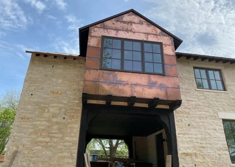 Copper metal panel facade on a stone building for Skylight Installation in Jackson
